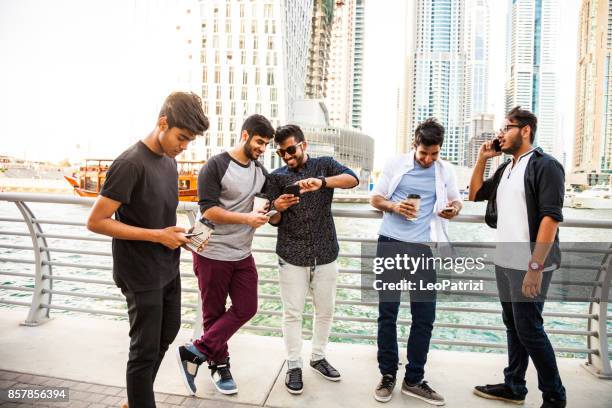 arab youth - group of middle eastern male friends hanging out in dubai - youth culture stock pictures, royalty-free photos & images