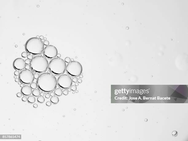 full frame of abstract shapes and textures formed on a white liquid background - bubbles white background stock pictures, royalty-free photos & images