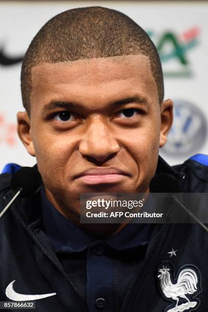 France's forward Kylian Mbappe reacts as he speaks during a press conference in Clairefontaine-en-Yvelines on October 5 as part of the team's...