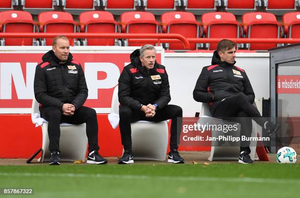 Assistant coach Henrik Pedersen, coach Jens Keller and assistant coach Sebastian Boenig of 1 FC Union Berlin look on before the game between Union...