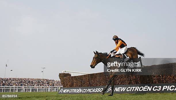 Denis O'Regan rides the horse' Killyglen' over the last hurdle to win The Mildmay Novices Steeple Chase during the second day of the Grand national...