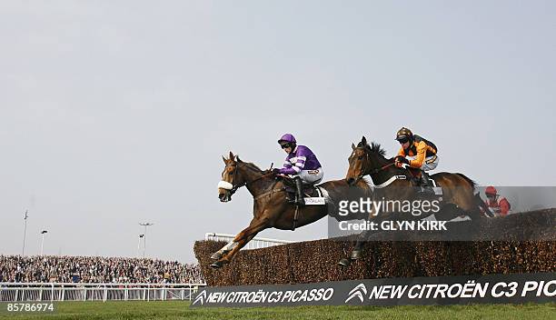 Denis O'Regan rides the horse' Killyglen' with Ruby walsh on the horse 'Herecomesthetruth' in the first circuit of The Mildmay Novices Steeple Chase...