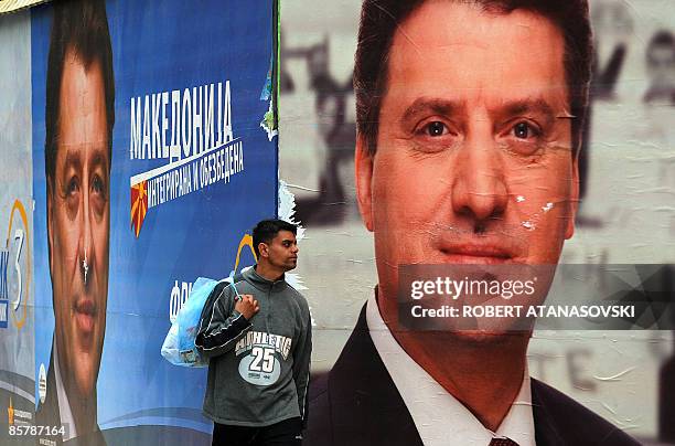 Man walks past a large election billboard of the presidential candidate of the ruling VMRO DPMNE party George Ivanov and the opposition SDSM party...