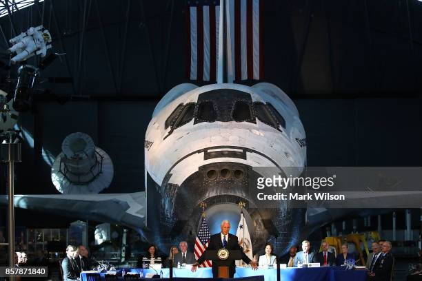 The Space Shuttle Discovery is the back drop as Vice President Mike Pence speaks during the inaugural meeting of the National Space Council on...