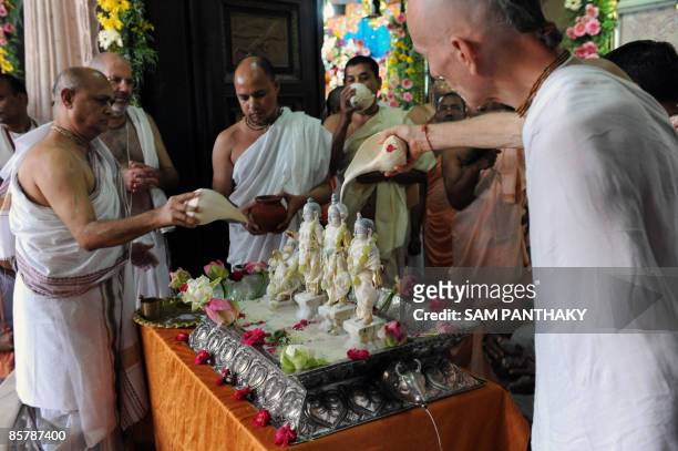 Hindu priests perform a ritual on bronze idols of Hindu deities Lord Rama , Goddess Sita , Laxman and Hanuman at the International Society for...