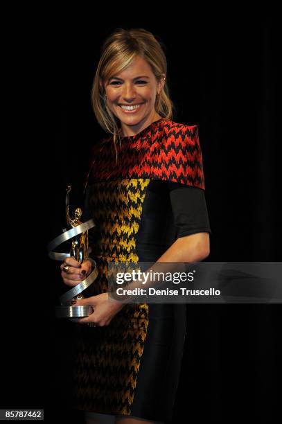 Supporting Actress of the Year Sienna Miller poses for photos in the press room at ShoWest 2009's Final Night Banquet And Award Ceremony on April 2,...