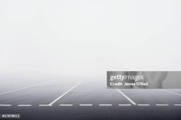 Empty carpark with thick fog