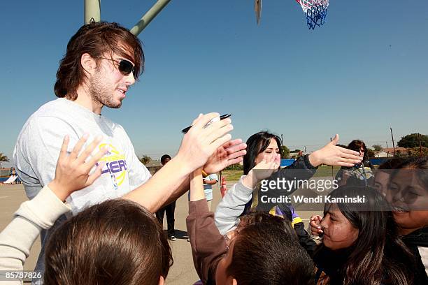Sasha Vujacic of the Los Angeles Lakers signs autographs for students during Anthem Blue Cross's "Fit for Life" nutrition campaign on March 16, 2009...