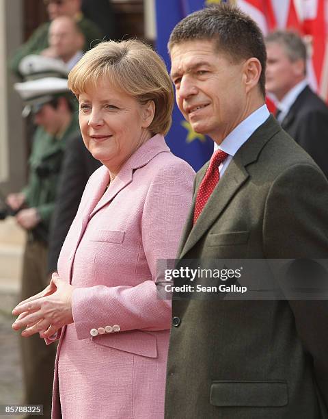 German Chancellor Angela Merkel and her husband Joachim Sauer wait for the arrival of U.S. President Barack Obama and his wife Michelle before...