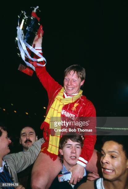 Sammy Lee holding the trophy, is carried by celebrating fans after Liverpool had beaten Everton 1-0 in the League Cup Final Replay, sponsored by the...