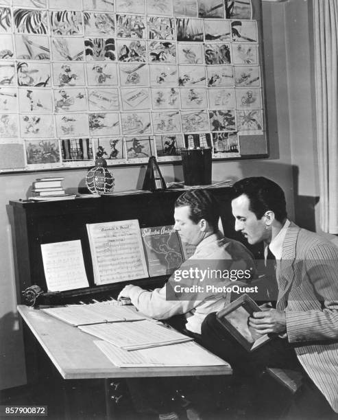 American composer Charles Wolcott plays piano with Brazilian singer Aloysio de Oliveira as they rehearse a song for the Walt Disney-produced film...