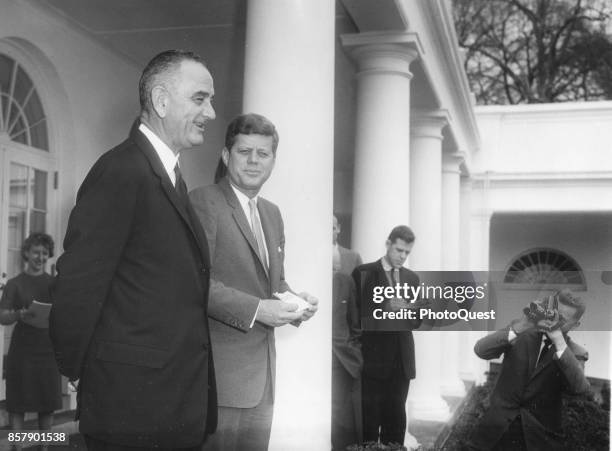 View of American politicians, Vice President Lyndon B Johnson and President John F Kennedy , as they meet with the press in the White House Rose...