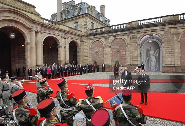 President Barack Obama and France's President Nicholas Sarkozy review troops during a welcoming ceremony as first ladies Michelle Obama and Carla...