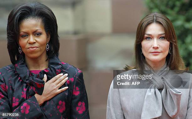 First lady Michelle Obama and France's first lady Carla Bruni-Sarkozy listen to national anthems, during a welcoming ceremony in Strasbourg on April...