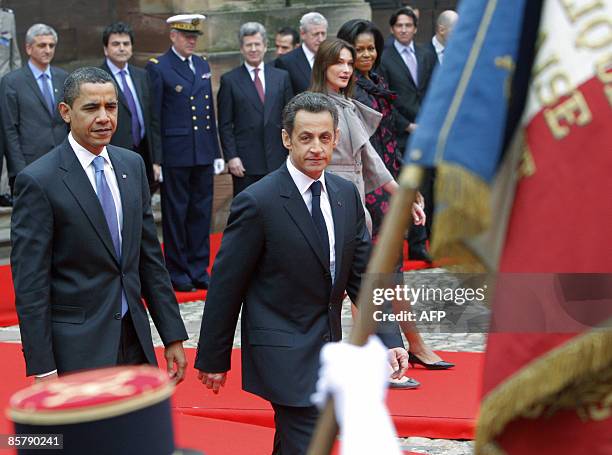 President Barack Obama and France's President Nicholas Sarkozy inspect an honour guard during a welcoming ceremony as first ladies Michelle Obama and...