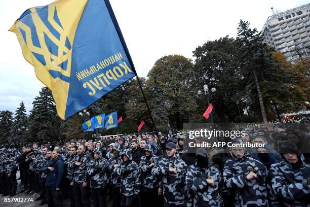 Ukrainian far-right parties activists gesture as they chant slogans during a demonstration in front of the Ukrainian Parliament during a session, in...