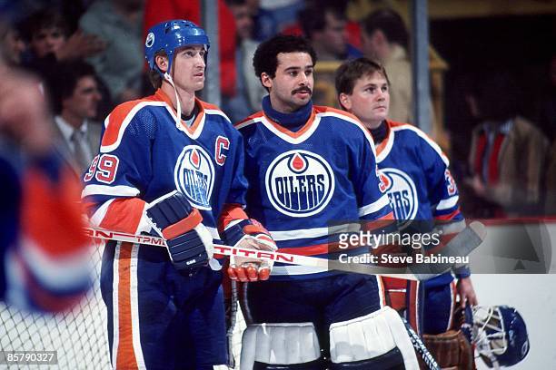 Wayne Gretzky, Grant Fuhr and Andy Moog of the Edmonton Oilers stand in the goalie crease prior to the game against the Boston Bruins at the Boston...