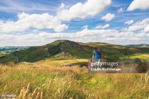 father and son hiking in peak district - derbyshire stock pictures, royalty-free photos & images