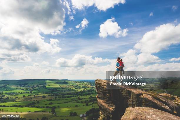 father and son hiking in peak district - peak district national park stock pictures, royalty-free photos & images