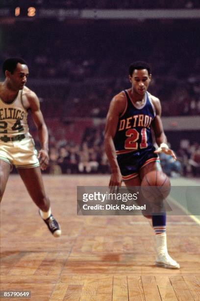 Dave Bing of the Detroit Pistons moves the ball up court against Sam Jones of the Boston Celtics during a game played in 1968 at the Boston Garden in...