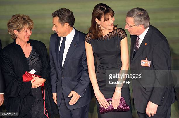 (Wife of Luxembourg Premier Jean-Claude Juncker, Christiane Frising speaks with French President Nicolas Sarkozy while Sarkozy's wife Carla...
