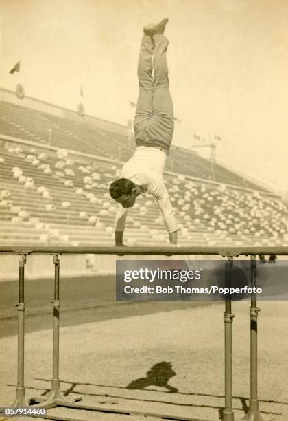 Alfred Flatow of Germany practices on the parallel bars gymnastics apparatus in an empty stadium prior to his first-place finish during the First...