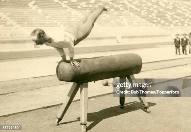 Carl Schuhmann of Germany practices on the vault gymnastics apparatus in an empty stadium prior to his first place finish during the First Summer...