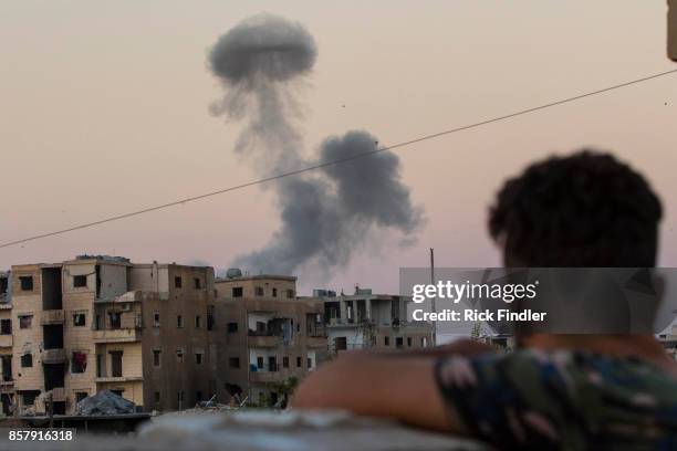 Smoke rises from a building believed to be housing ISIS, after being hit by a mortar round fired from a United States military base on August 18,...