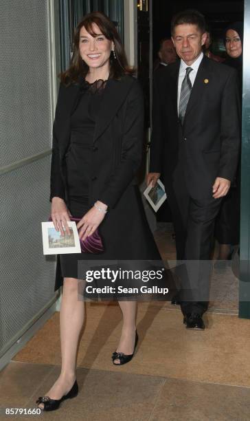 Carla Bruni-Sarkozy, wife of French President Nicolas Sarkozy, and Joachim Sauer, husband of German Chancellor Angela Merkel, arrive for the spouses'...