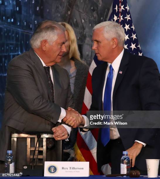 Vice President Mike Pence , and Secretary of State Rex Tillerson shake hands at the end of the inaugural meeting of the National Space Council,...