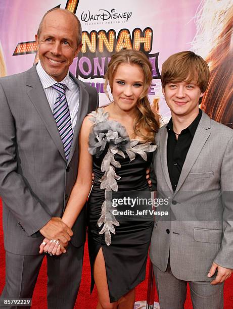 Director Peter Chelsom, actress Emily Osment, and actor Jason Earles arrive at the premiere of Walt Disney Picture's "Hannah Montana: The Movie" held...