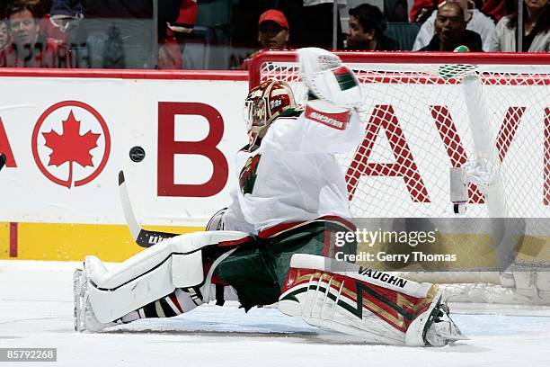 Niklas Backstrom of the Minnesota Wild sprawls to make a save against the Calgary Flames on March 28, 2009 at Pengrowth Saddledome in Calgary,...