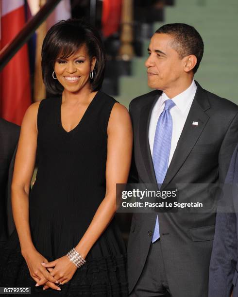 First Lady Michelle Obama and U.S. President Barack Obama, pose as they arrive to attend the opening of the NATO summit at the Kurhaus on April 3,...