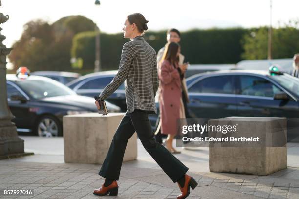 Guest wears a blazer jacket, flare pants, brown leather shoes, outside Louis Vuitton, during Paris Fashion Week Womenswear Spring/Summer 2018, on...