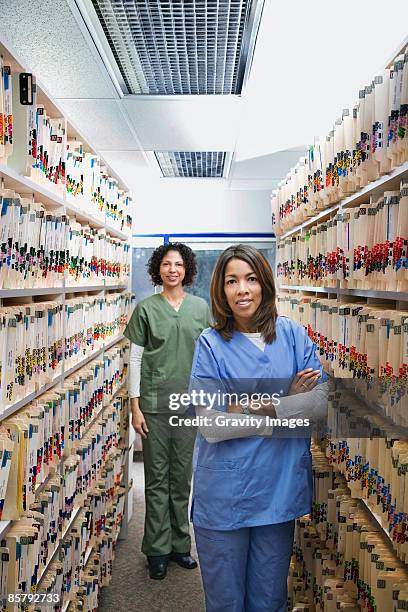 mixed race nurses standing in front of files - archive 2008 stock pictures, royalty-free photos & images