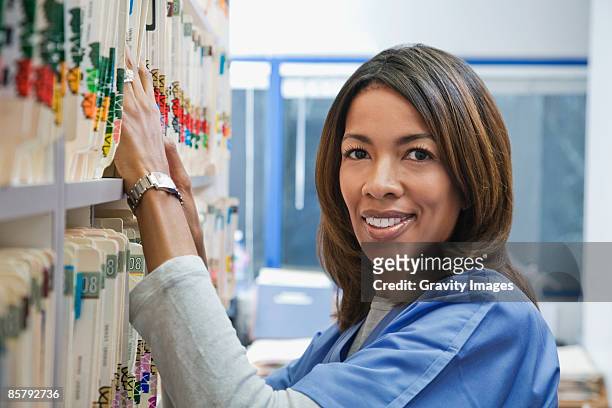 afican america nurse looking at medical charts - archive 2008 stock pictures, royalty-free photos & images