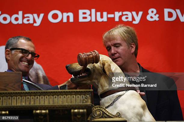 Director David Frankel and Marley ring the closing bell at the New York Stock Exchange on April 3, 2009 in New York City.