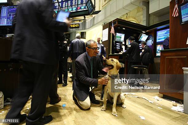 Director David Frankel and Marley pose for a photograph on the trading floor after the closing bell at the New York Stock Exchange on April 3, 2009...