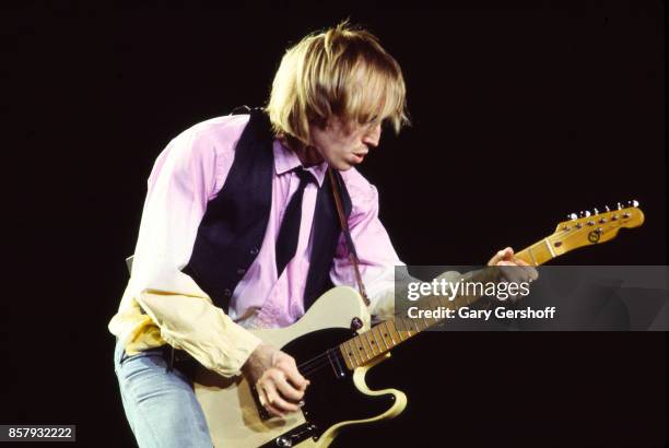 American Rock and Pop musician Tom Petty plays guitar as he leads his band, the Heartbreakers, during a performance on the 'Long After Dark' tour at...