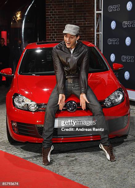 Singer Tobey Wilson poses with the new Golf GTI during the premiere of the Volkswagen Golf GTI at 'ewerk' on April 3, 2009 in Berlin, Germany.