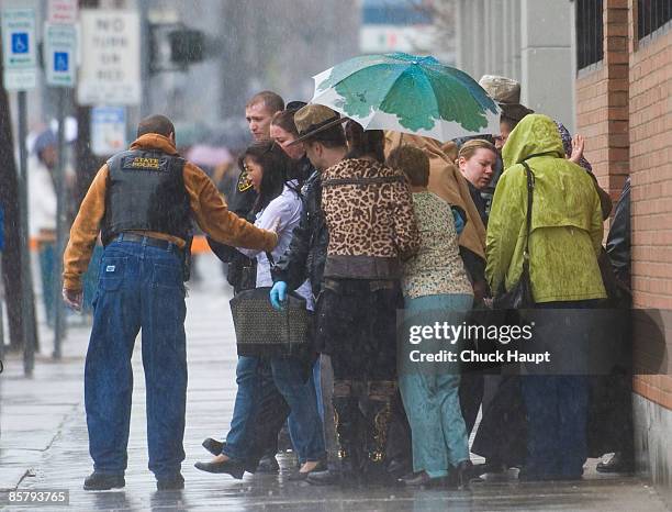 Group of hostages is comforted by police after being escorted from the building during a siege at the American Civic Association April 3, 2009 in...