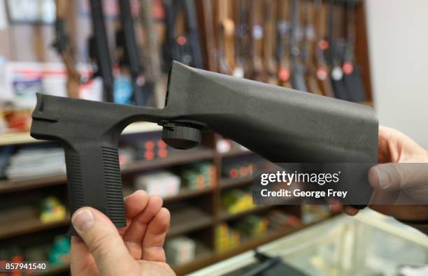 Bump stock device that fits on a semi-automatic rifle to increase the firing speed, making it similar to a fully automatic rifle, is shown here at a...