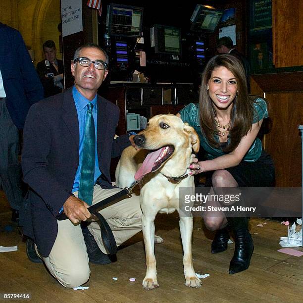 Director David Frankel, Marley and Lynda Lopez pose at the New York Stock Exchange on April 3, 2009 in New York City.
