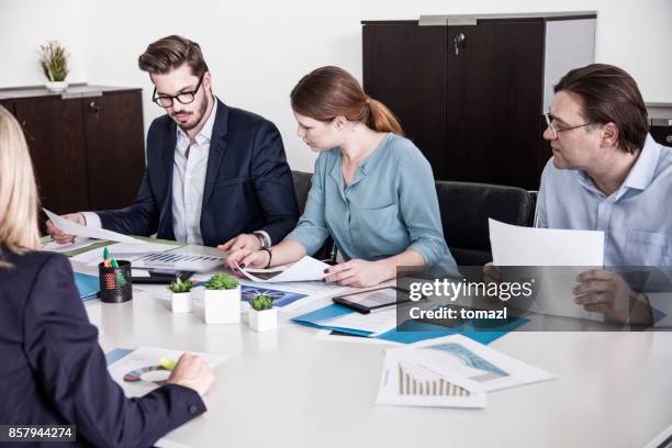 business people at meeting table - financial result stock pictures, royalty-free photos & images