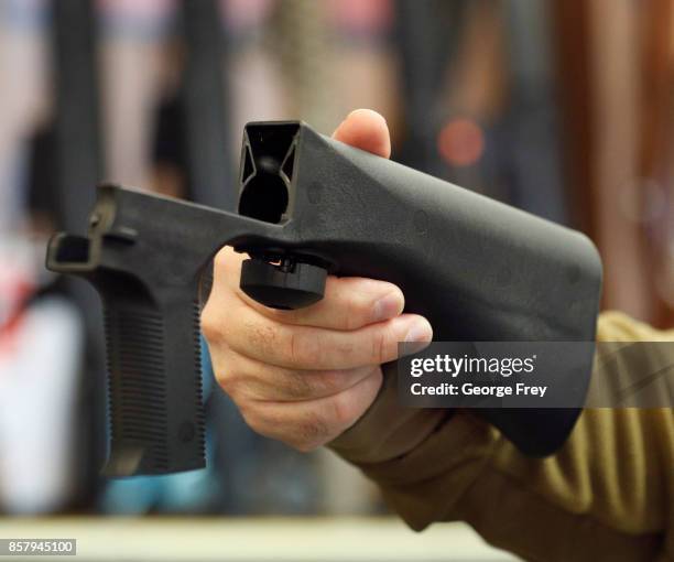 Bump stock device that fits on a semi-automatic rifle to increase the firing speed, making it similar to a fully automatic rifle, is shown here at a...