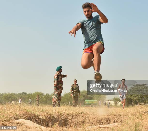 Candidate jumps during a physical fitness test at an Indian Army recruitment rally at Khasa near on October 5, 2017 in Amritsar, India.