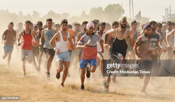 Candidates run during their physical fitness test at an Indian Army recruitment rally at Khasa near on October 5, 2017 in Amritsar, India.