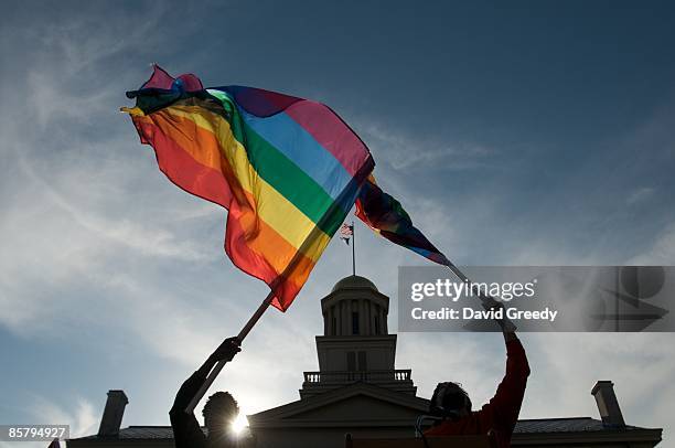 Gay, lesbian and transgender activists react to the unanimous decision by the Iowa Supreme Court earlier in the day recognizing same sex marriage as...