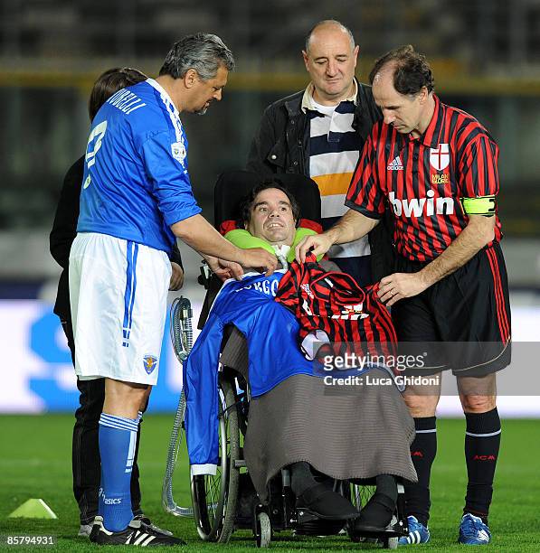 Alessandro Altobelli and Franco Baresi greet Stefano Borgonovo before the charity football match between Milan Glorie and Brescia Glorie at the...