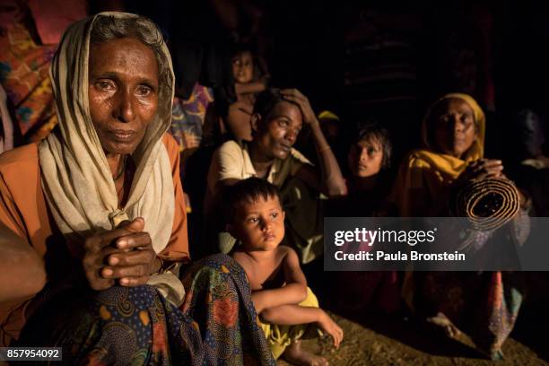 New arrivals rest after a long truck ride from the border without any knowledge of where to go next on October 5, 2017 in Kutupalong, Cox's Bazar,...